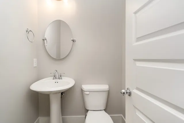 a bedroom with a balcony a bed and a potted plant