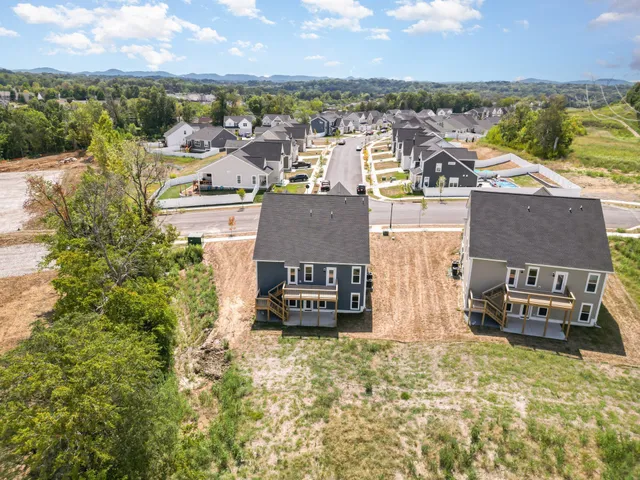 an aerial view of residential houses with outdoor space