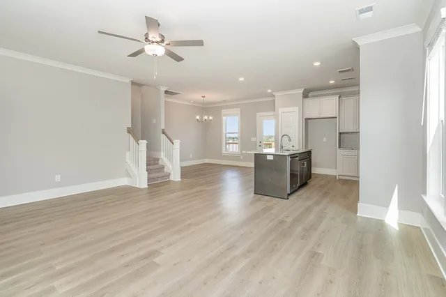 a room with wooden floor and windows