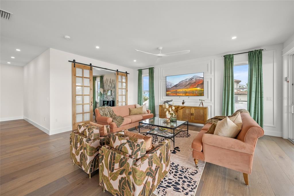 525 68th Street Holmes Beach, FL 34217 - Photo 17 of 52 a living room with furniture large windows and wooden floor