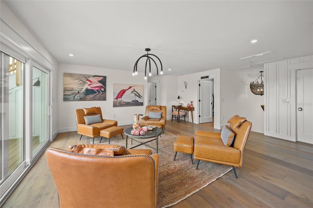 525 68th Street Holmes Beach, FL 34217 - Photo 25 of 52 a living room with furniture a rug and white walls