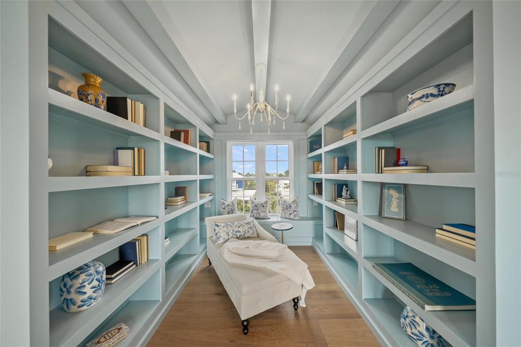 525 68th Street Holmes Beach, FL 34217 - Photo 30 of 52 a living room with furniture and a book shelf