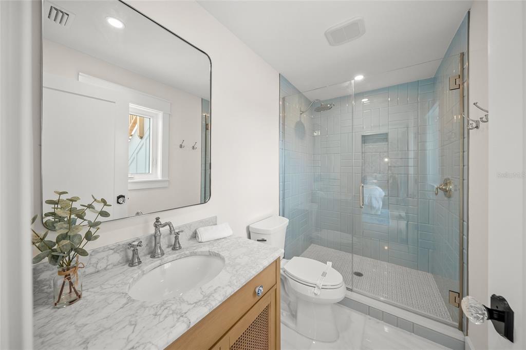 525 68th Street Holmes Beach, FL 34217 - Photo 31 of 52 a bathroom with a granite countertop sink a toilet and shower