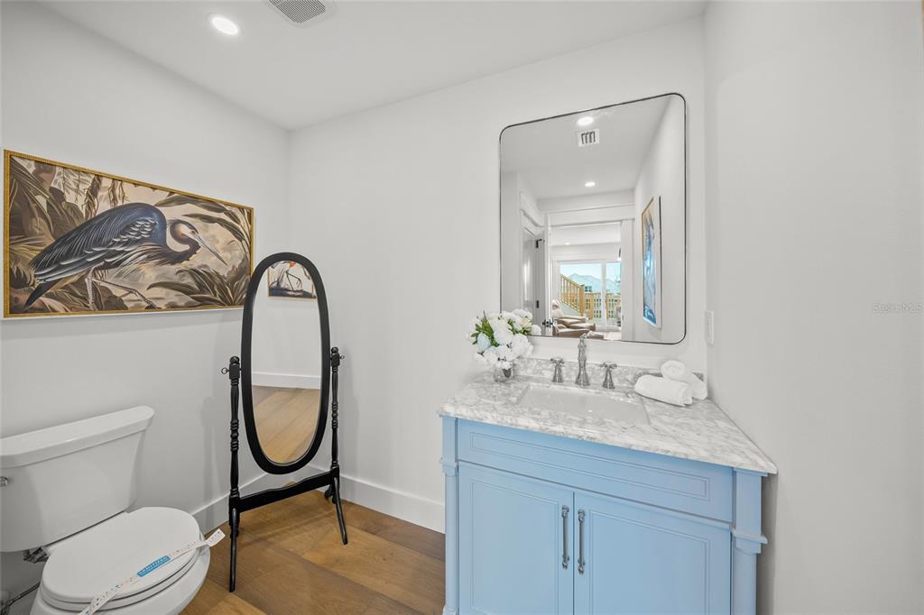 525 68th Street Holmes Beach, FL 34217 - Photo 32 of 52 a bathroom with a toilet sink and mirror