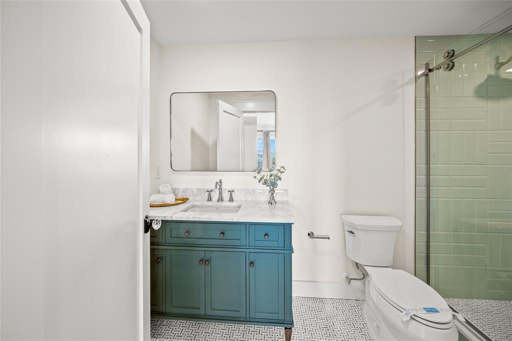 525 68th Street Holmes Beach, FL 34217 - Photo 35 of 52 a bathroom with a toilet a sink a mirror and shower