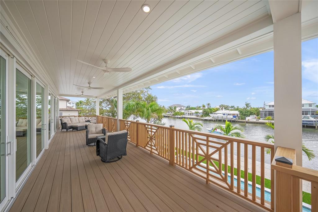 525 68th Street Holmes Beach, FL 34217 - Photo 42 of 52 a view of a balcony with chairs and wooden floor