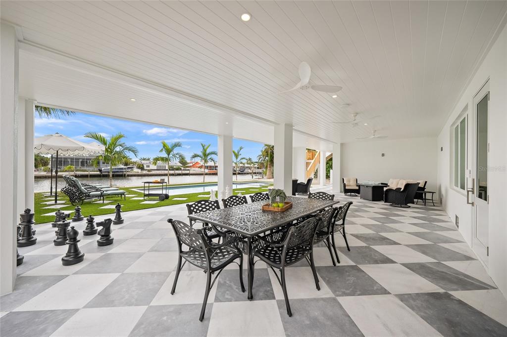 525 68th Street Holmes Beach, FL 34217 - Photo 45 of 52 a view of a dining room with furniture one side kitchen view and wooden floor
