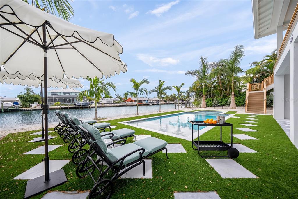 525 68th Street Holmes Beach, FL 34217 - Photo 46 of 52 a swimming pool with outdoor seating and yard