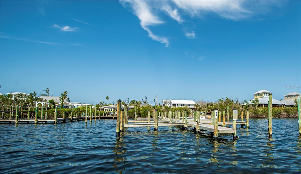 8864 Bay Street Boca Grande, FL 33921 - Photo 23 of 25 a view of a lake with boats and trees in the background