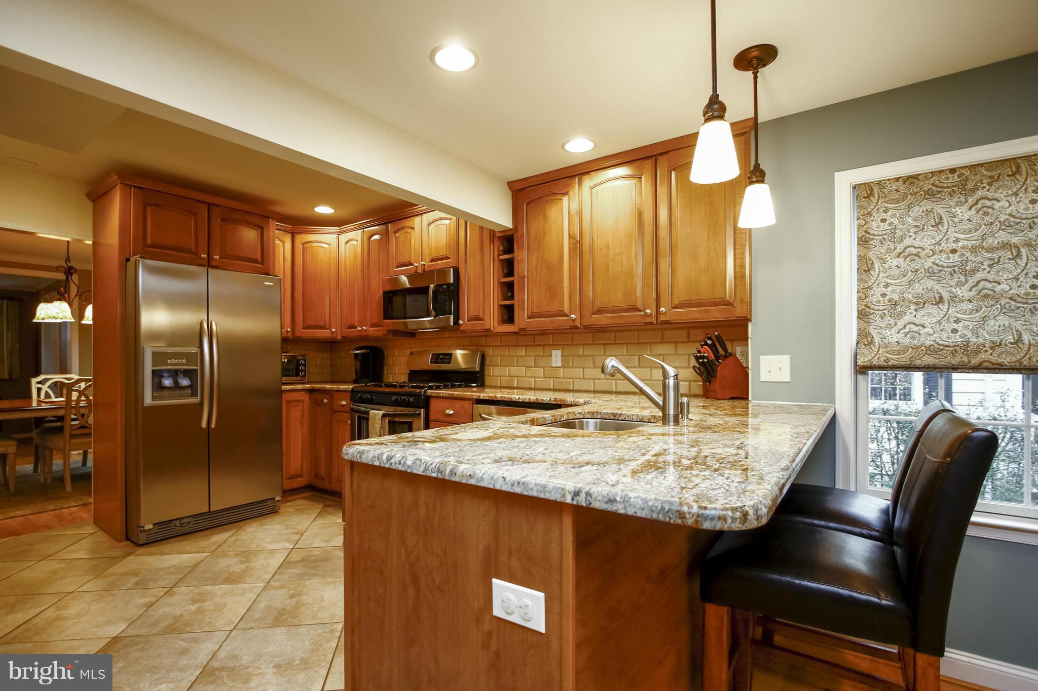 929 Litchfield Road Baltimore, MD 21239 - Photo 14 of 29 a kitchen with stainless steel appliances granite countertop a sink refrigerator and cabinets