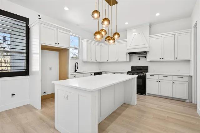 a kitchen with white cabinets and white appliances