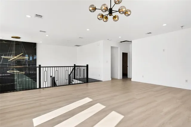 a view of a room with a window and a ceiling fan