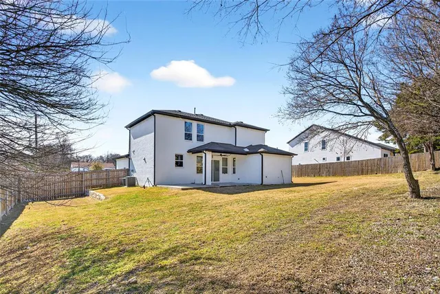 a view of a house with a yard covered with snow