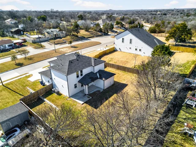 an aerial view of residential houses with outdoor space