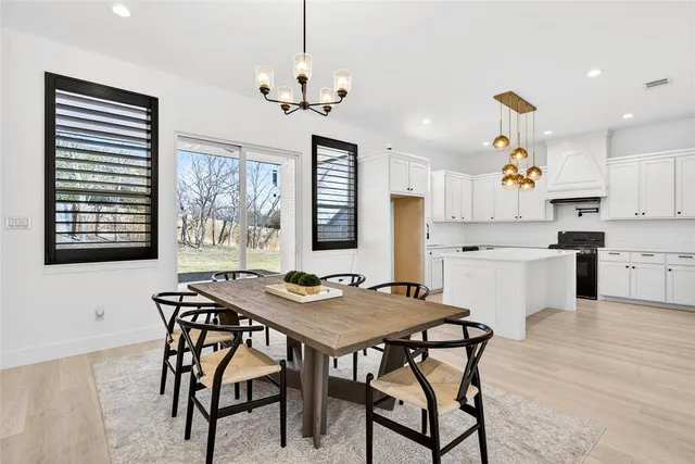 a view of a dining room with furniture wooden floor and chandelier