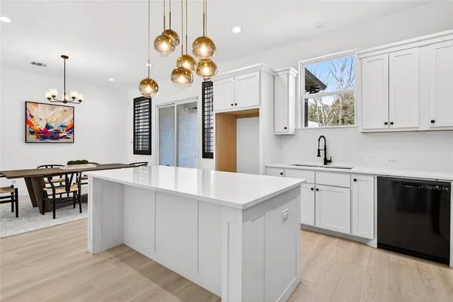 a kitchen with cabinets a sink and dishwasher