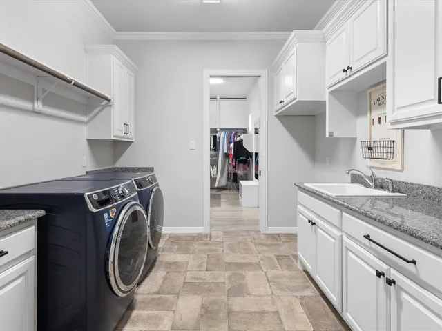a spacious bedroom with a bed and a flat screen tv