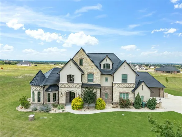 a front view of a house with a garden and plants