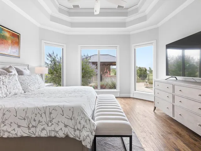 a bathroom with a granite countertop tub sink and mirror