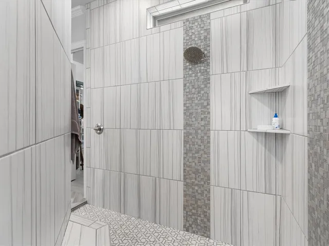 a bathroom with a granite countertop tub sink and mirror