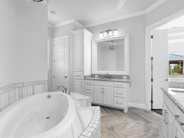 a bathroom with a granite countertop sink a toilet and mirror