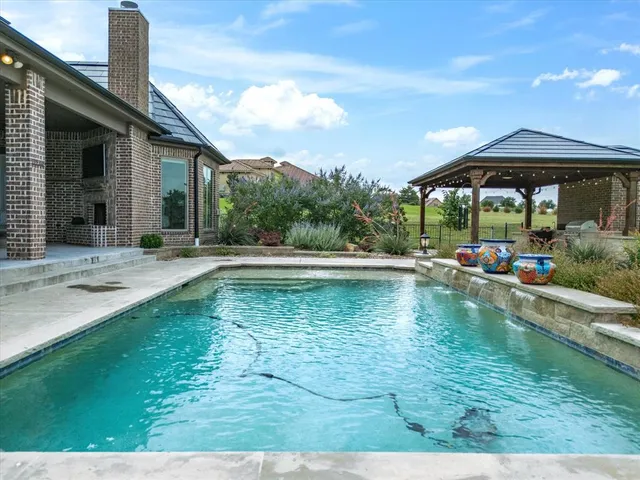 a swimming pool view with a seating space