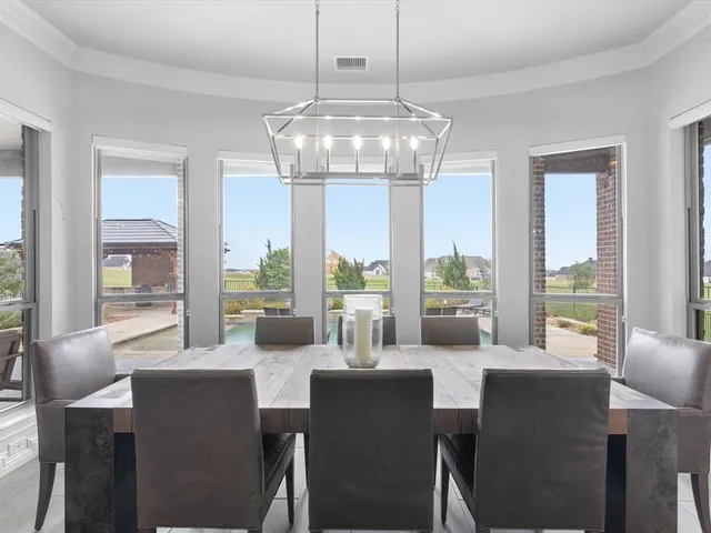 a kitchen with kitchen island a dining table and stainless steel appliances