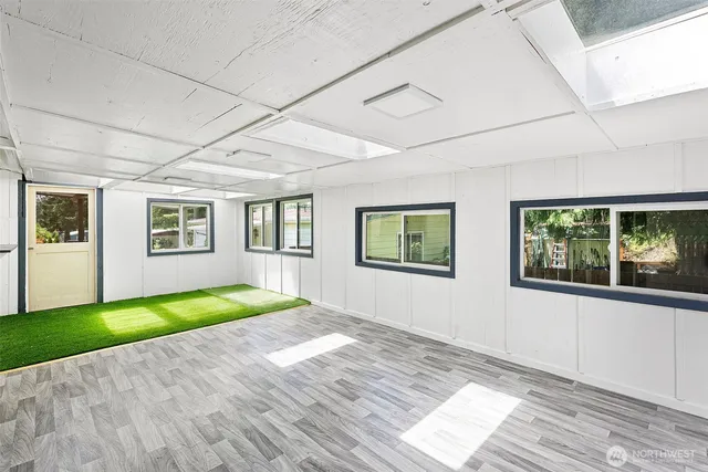 a view of backyard with swimming pool and seating space