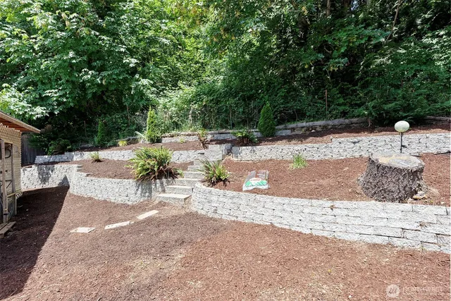 a view of a backyard with wooden fence