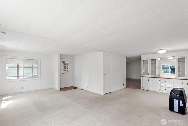 an empty room with windows and entrance