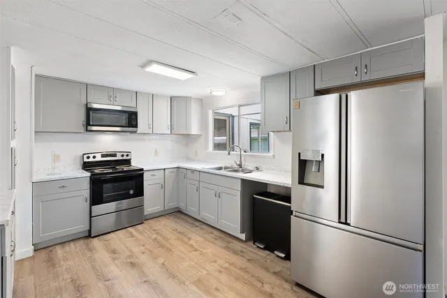 a kitchen with a refrigerator stove and microwave