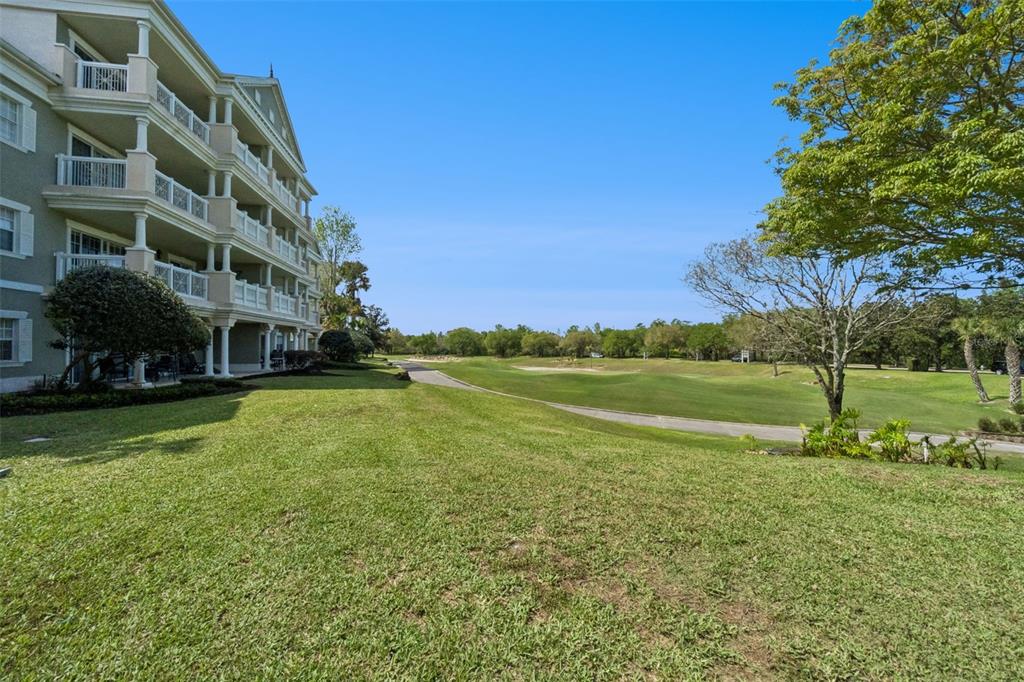 1352 Centre Ct Ridge Drive, Unit 302 Reunion, FL 34747 - Photo 11 of 42 a view of building with yard