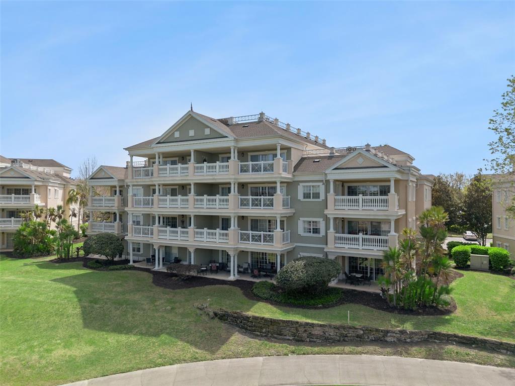 1352 Centre Ct Ridge Drive, Unit 302 Reunion, FL 34747 - Photo 16 of 42 a front view of a building with a garden