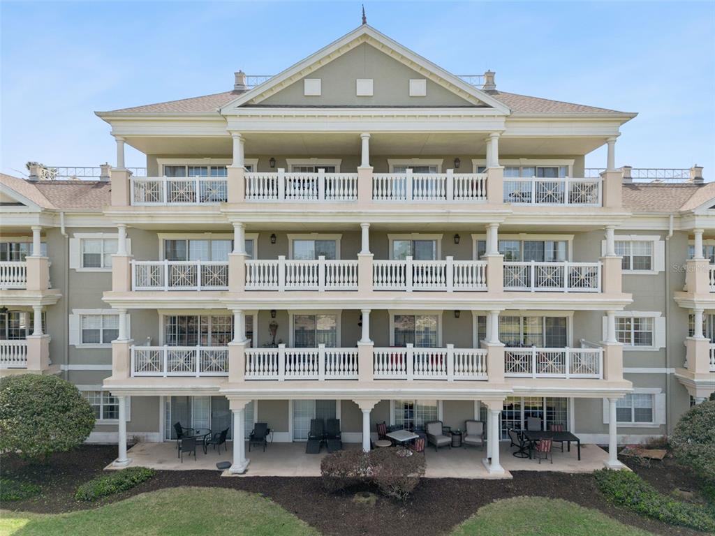 1352 Centre Ct Ridge Drive, Unit 302 Reunion, FL 34747 - Photo 18 of 42 a front view of a building with a yard