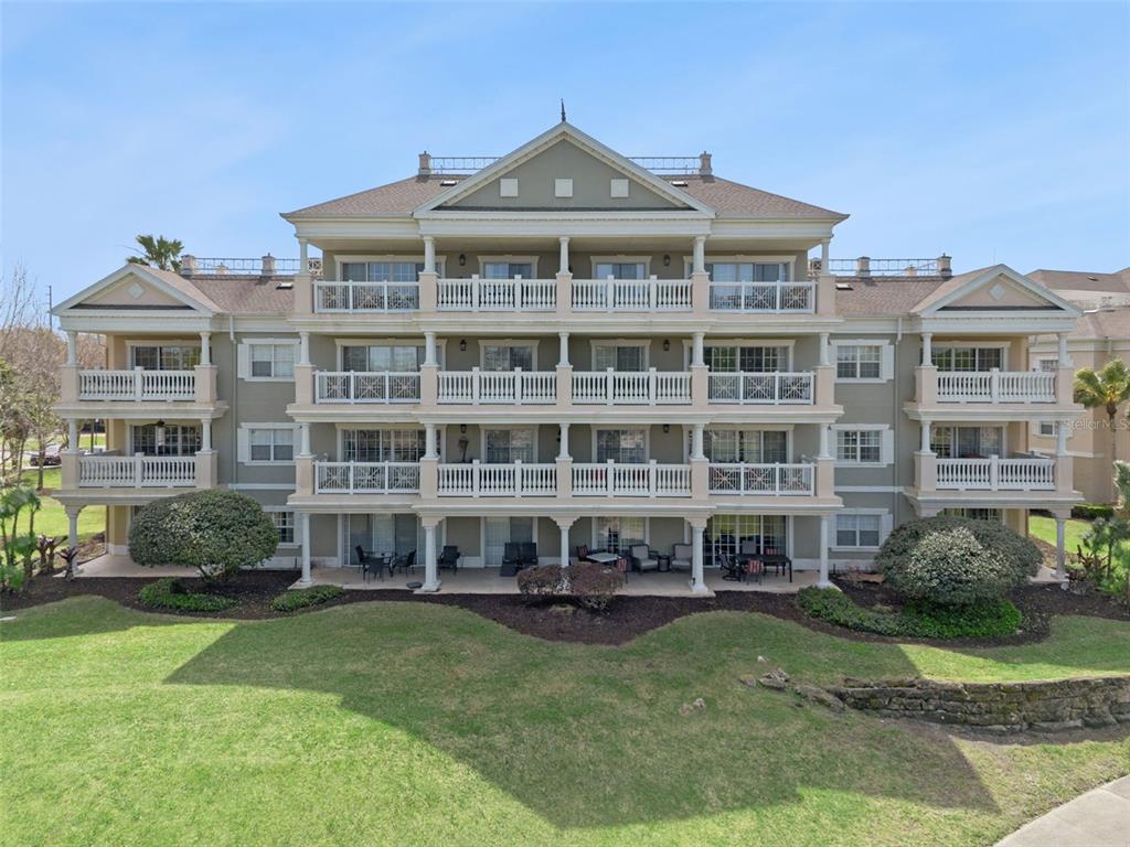 1352 Centre Ct Ridge Drive, Unit 302 Reunion, FL 34747 - Photo 19 of 42 a front view of a house with a garden