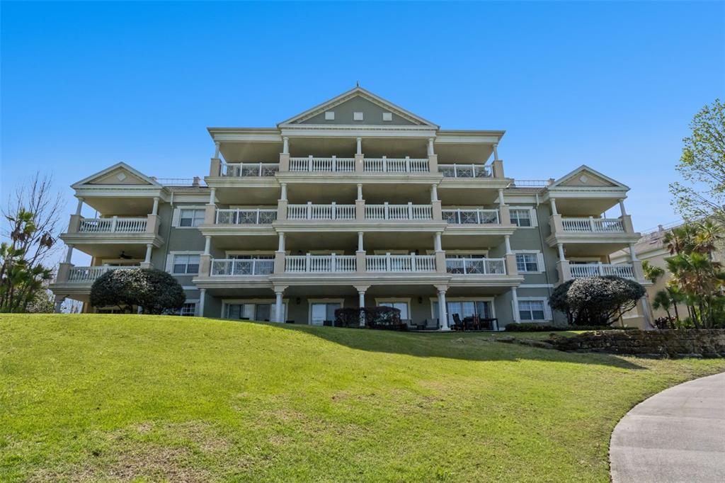 1352 Centre Ct Ridge Drive, Unit 302 Reunion, FL 34747 - Photo 9 of 42 a front view of a building with a garden