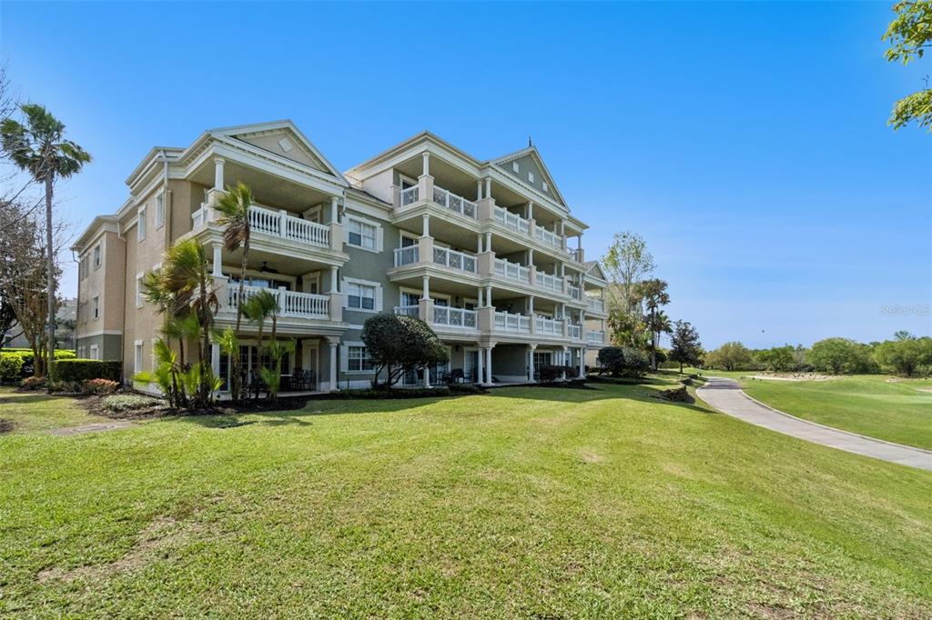 1352 Centre Ct Ridge Drive, Unit 302 Reunion, FL 34747 - Photo 10 of 42 a view of a building with a yard