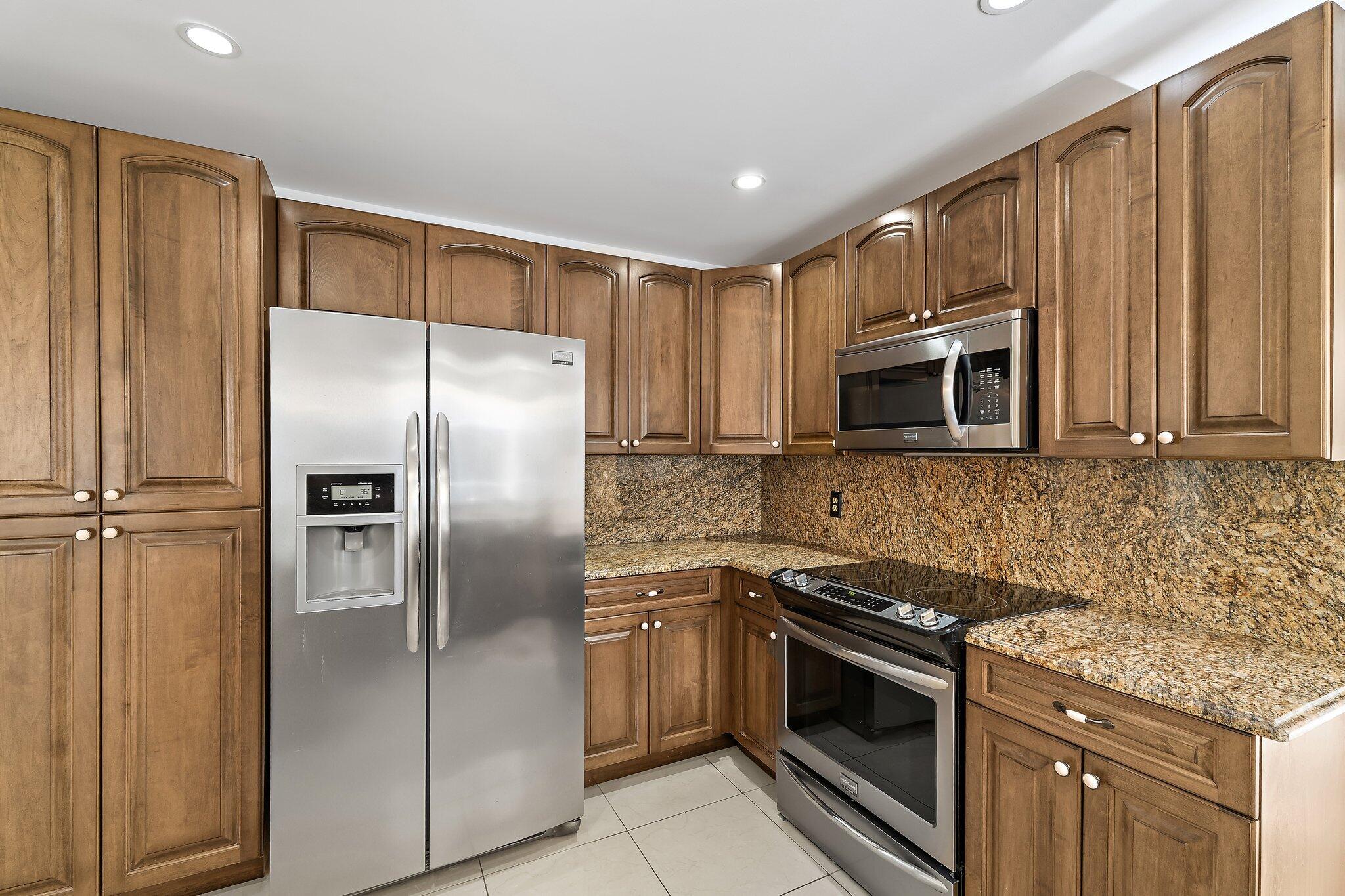18799 Rio Vista Drive Jupiter, FL 33469 - Photo 12 of 58 a kitchen with a refrigerator stove and microwave