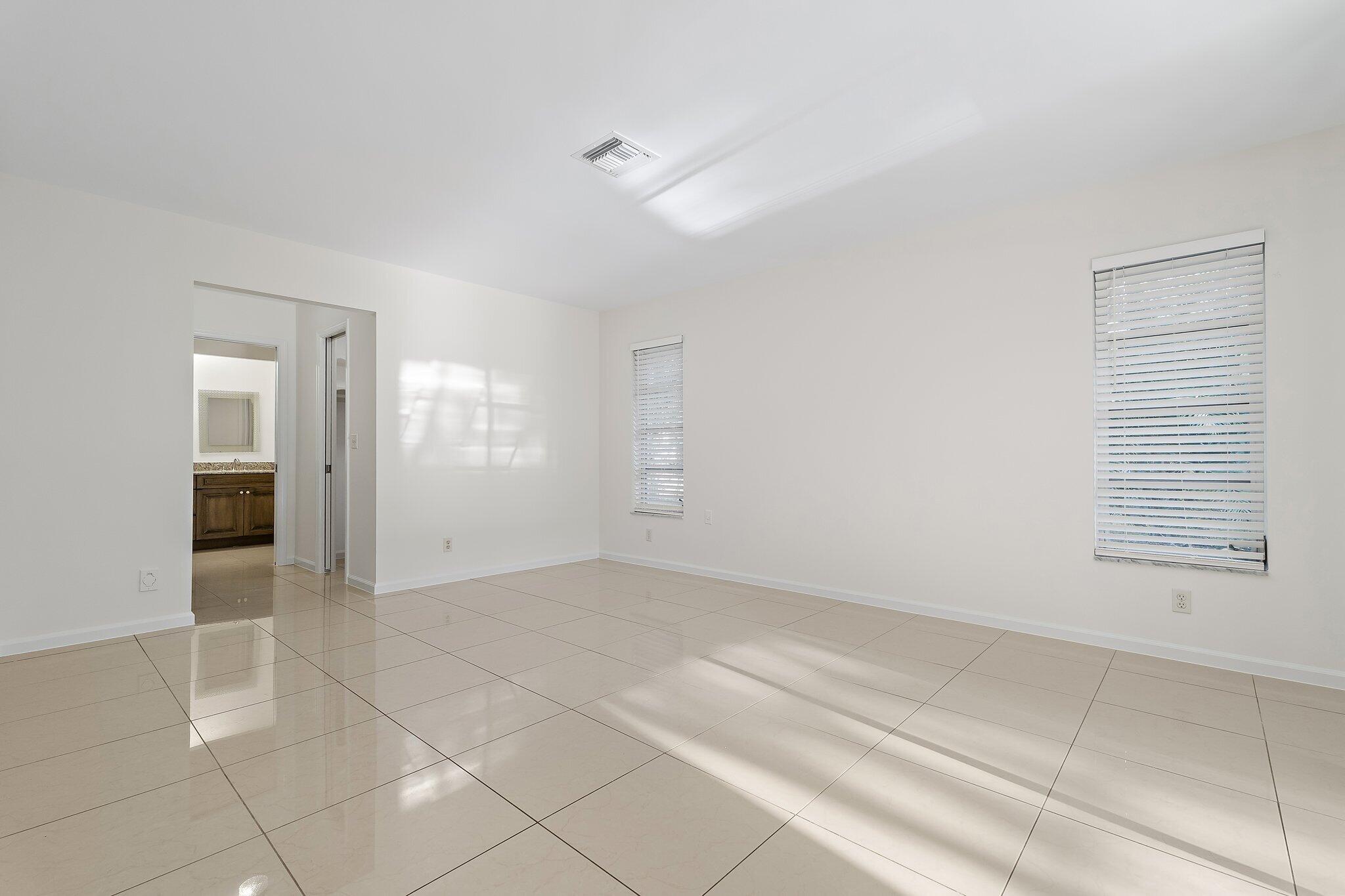 18799 Rio Vista Drive Jupiter, FL 33469 - Photo 22 of 58 wooden floor in an empty room with a window