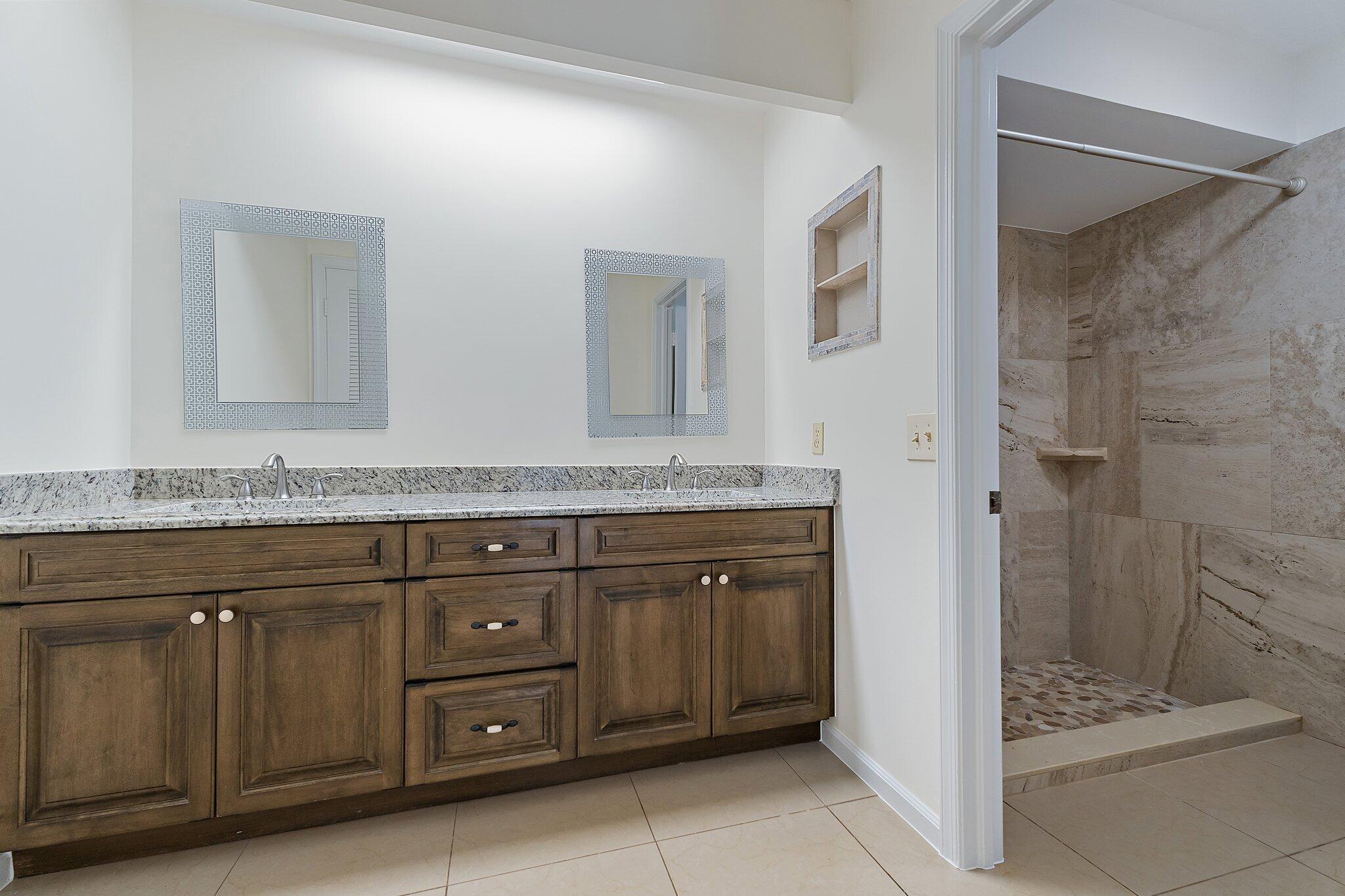 18799 Rio Vista Drive Jupiter, FL 33469 - Photo 25 of 58 a bathroom with a granite countertop sink mirror and