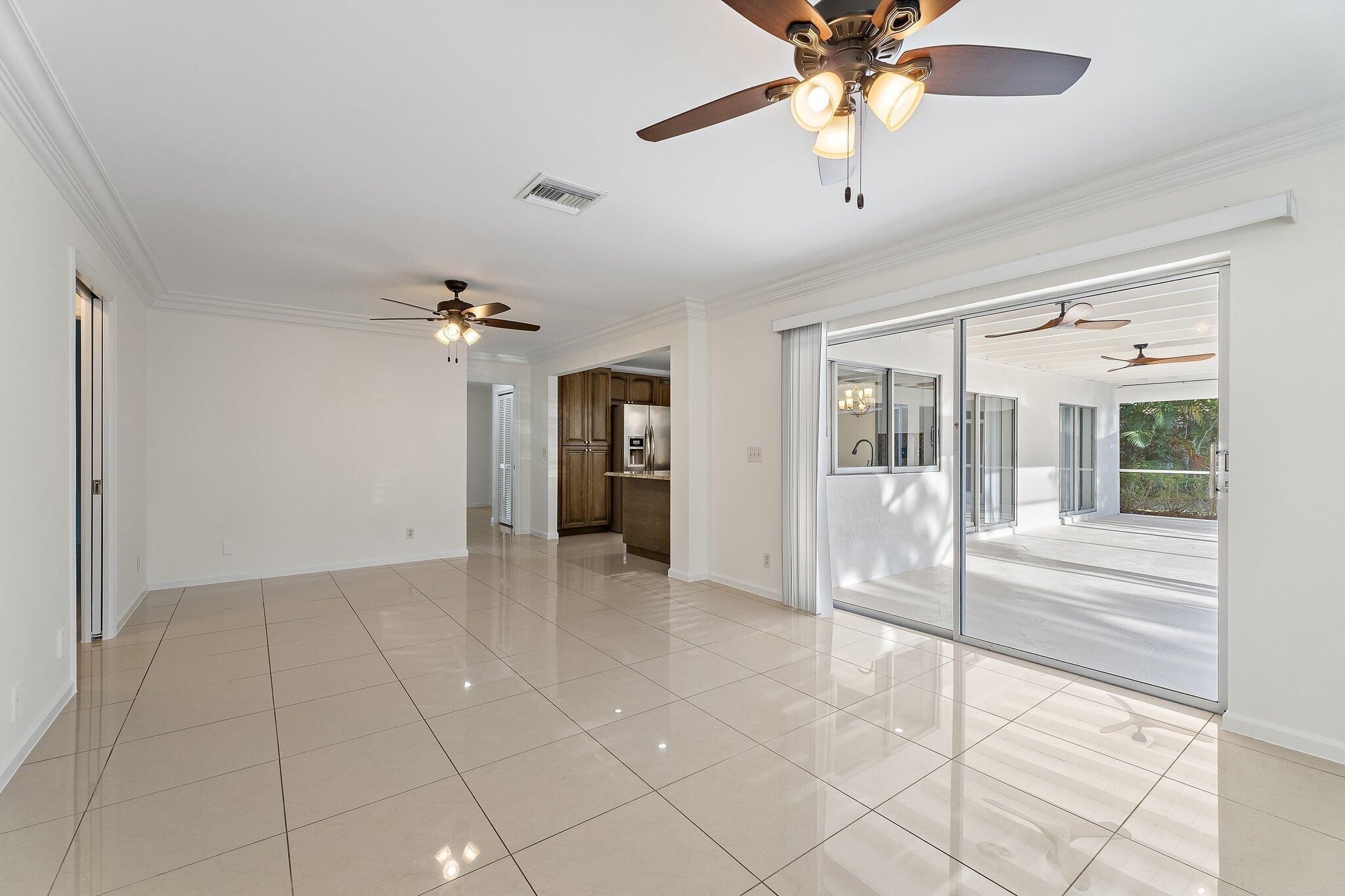 18799 Rio Vista Drive Jupiter, FL 33469 - Photo 31 of 58 a view of a livingroom with a chandelier fan and windows