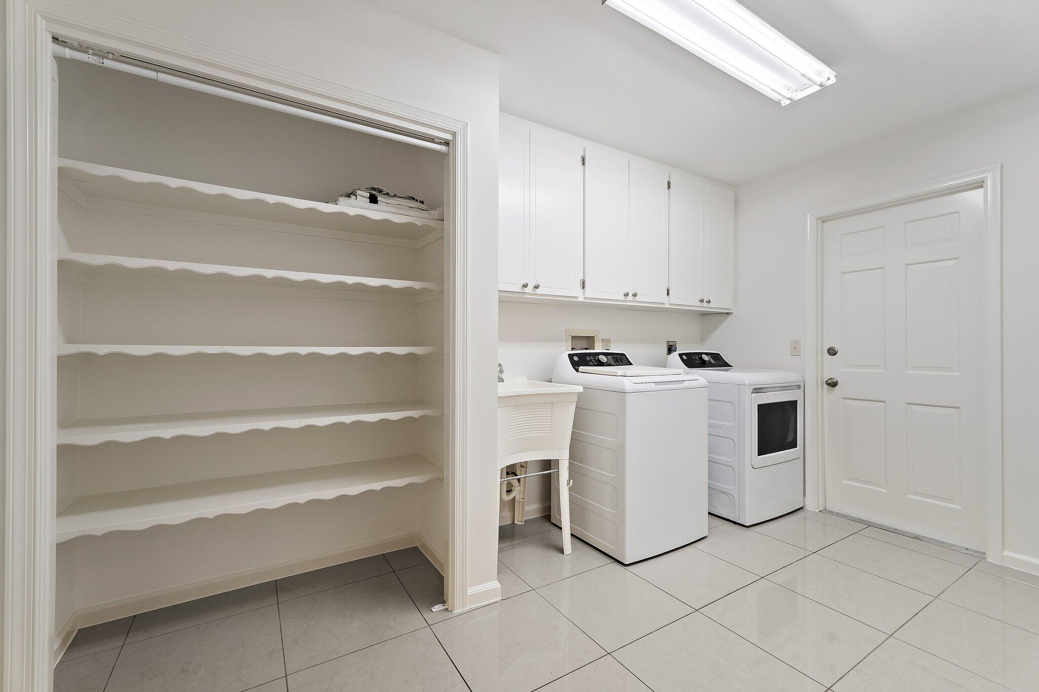18799 Rio Vista Drive Jupiter, FL 33469 - Photo 38 of 58 a kitchen with white cabinets and white appliances
