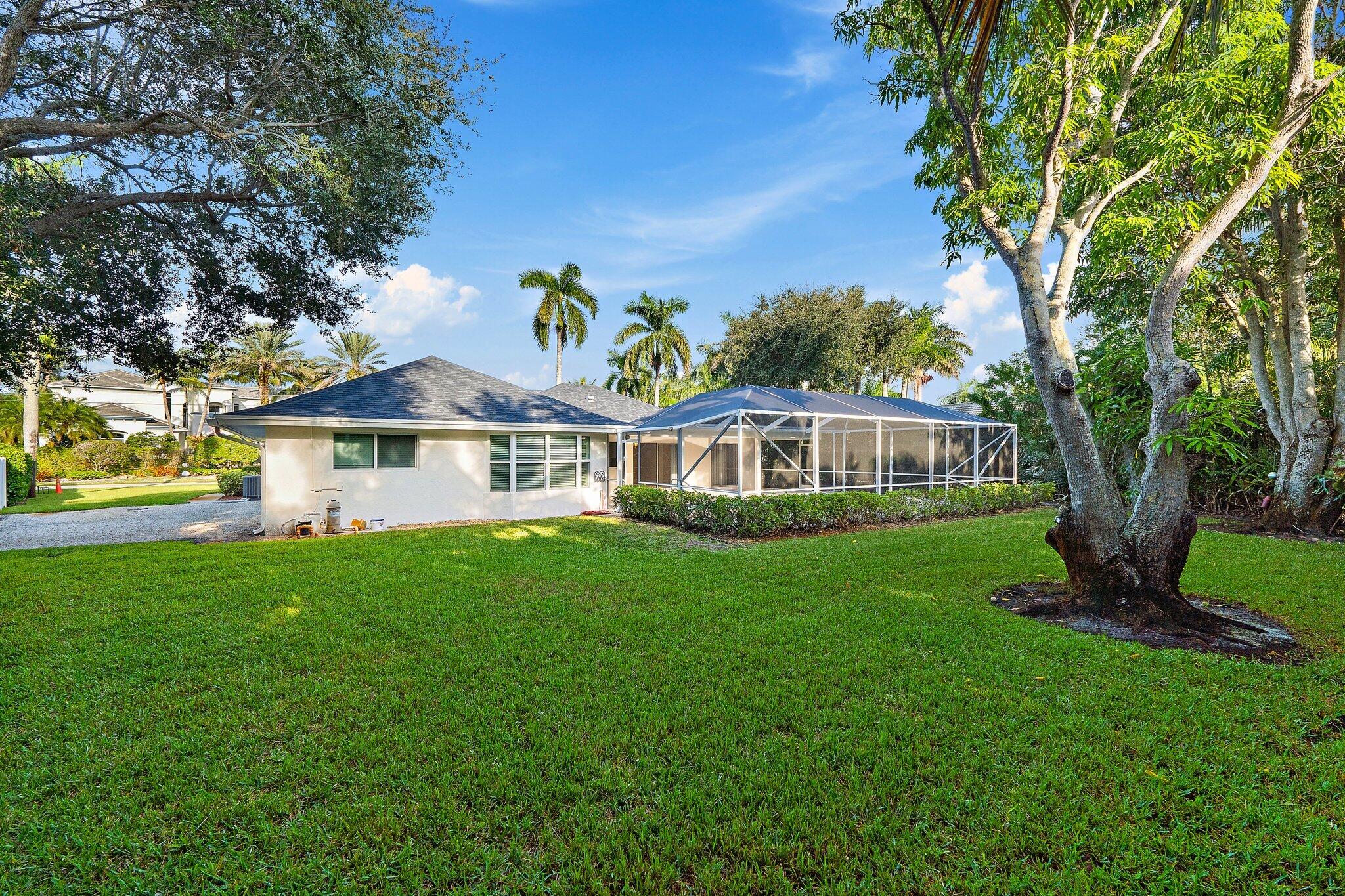 18799 Rio Vista Drive Jupiter, FL 33469 - Photo 40 of 58 a front view of a house with a garden