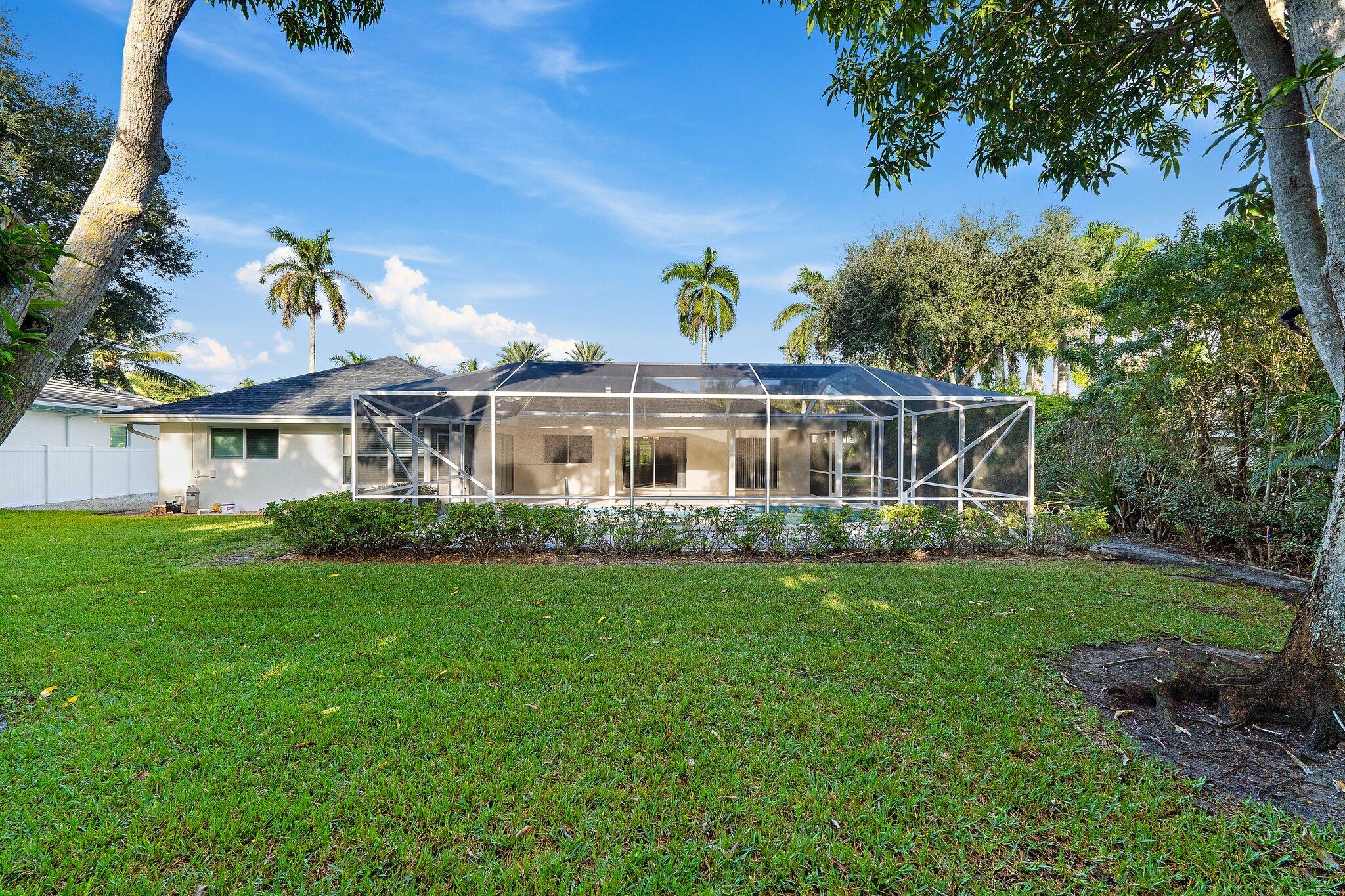 18799 Rio Vista Drive Jupiter, FL 33469 - Photo 41 of 58 a front view of a house with a garden
