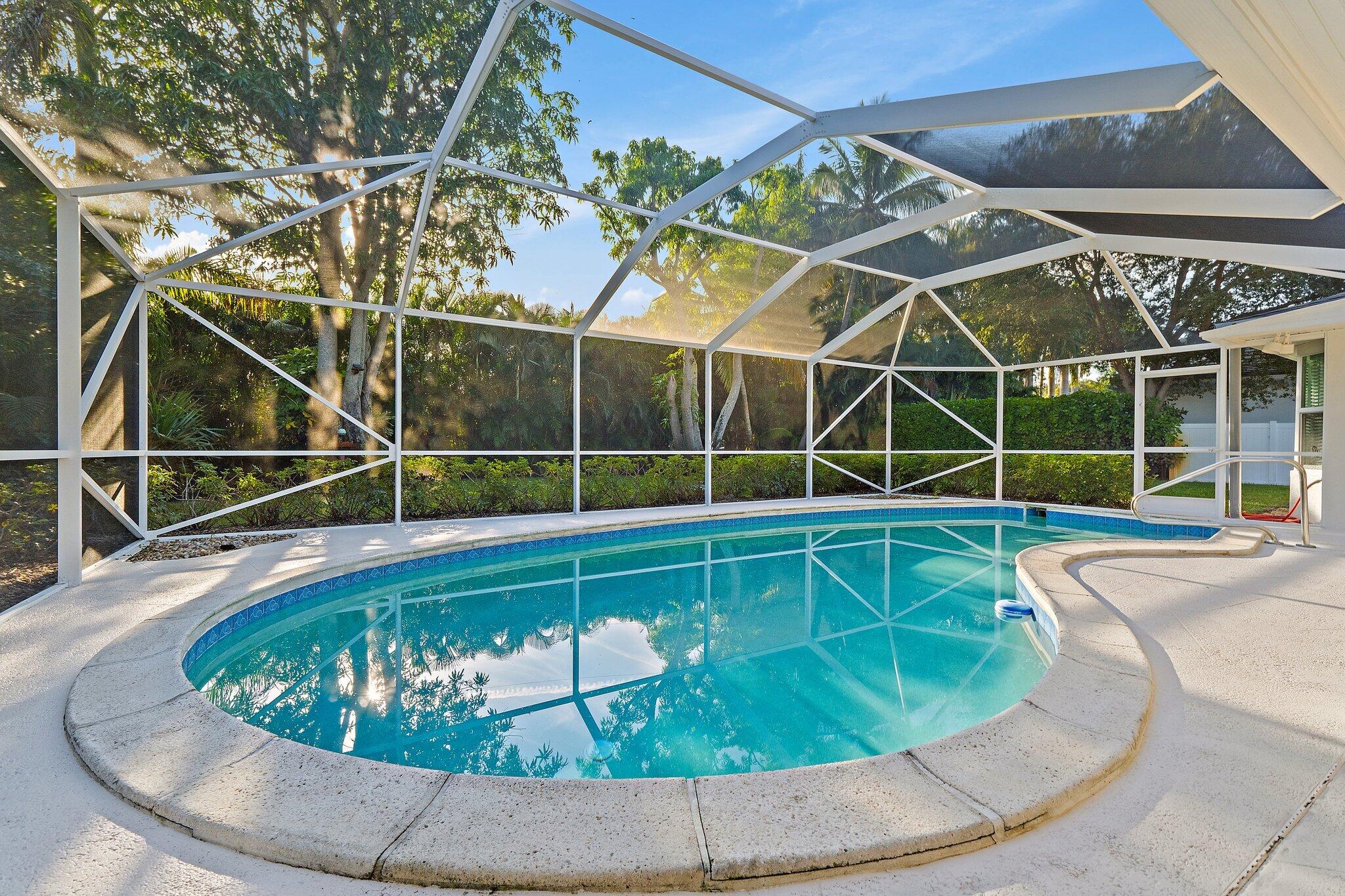 18799 Rio Vista Drive Jupiter, FL 33469 - Photo 43 of 58 a view of a swimming pool with a porch and a potted plant