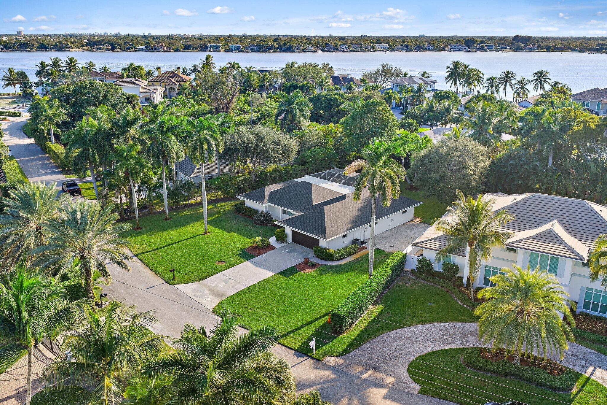 18799 Rio Vista Drive Jupiter, FL 33469 - Photo 46 of 58 an aerial view of a residential houses with outdoor space and lake view