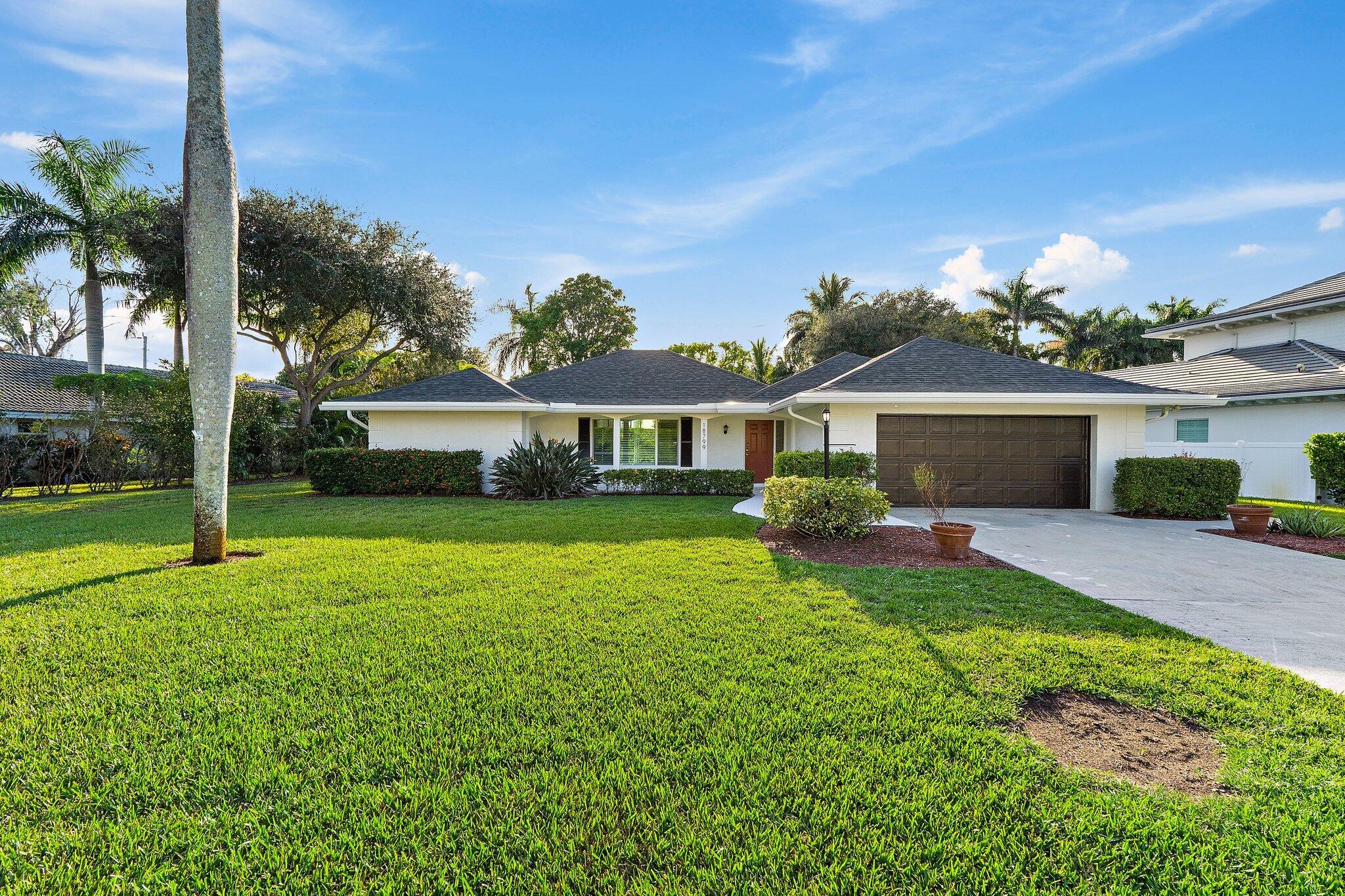 18799 Rio Vista Drive Jupiter, FL 33469 - Photo 47 of 58 front view of a house with a yard