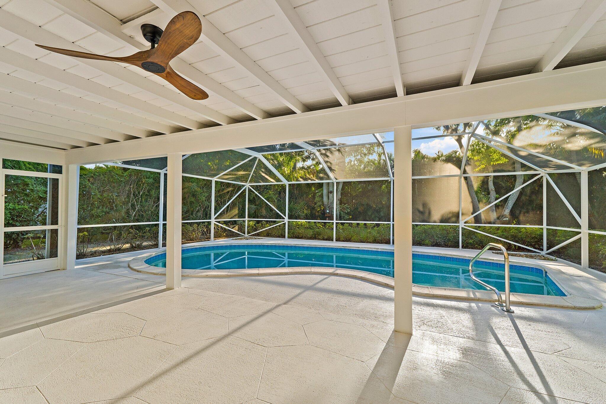 18799 Rio Vista Drive Jupiter, FL 33469 - Photo 6 of 58 a view of an empty room with wooden floor and windows