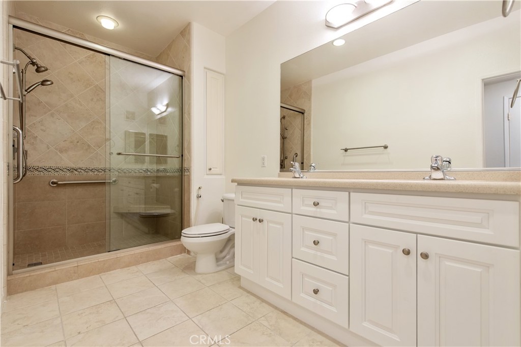 3261 Watermarke Place Irvine, CA 92612 - Photo 12 of 31 a bathroom with a double vanity sink toilet and shower