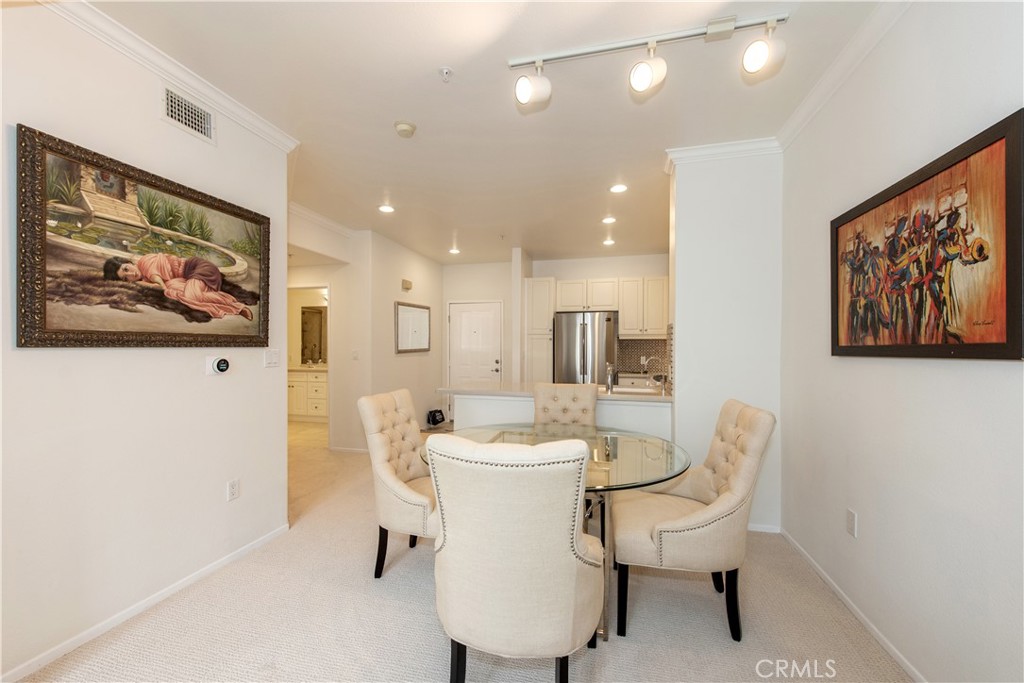 3261 Watermarke Place Irvine, CA 92612 - Photo 4 of 31 a dining room with furniture and a painting